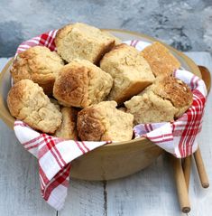 a bowl filled with biscuits on top of a wooden table