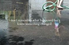 a person with a hose on top of a wet ground next to a fire hydrant that says i don't remember what happened but i know something changed