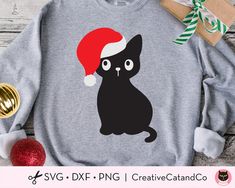 a black cat with a santa hat on it's head