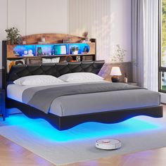 a bed that has some lights on the headboard and foot board in front of it