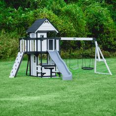 a play set in the grass with a slide and swings