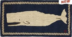 a blue and white rug with a whale on it's side, in the shape of a fish