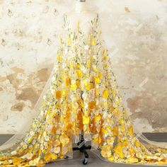 a yellow and white dress with flowers on it