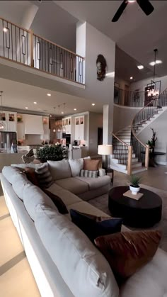 a living room filled with furniture and a spiral stair case in the middle of it