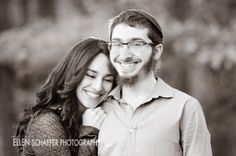 black and white photograph of a man and woman smiling at the camera with their arms around each other