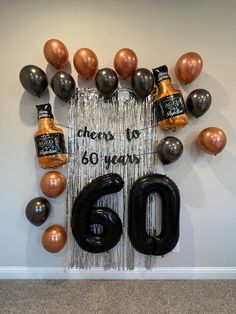 balloons and confetti are arranged in the shape of a sign that reads cheers to 60 years