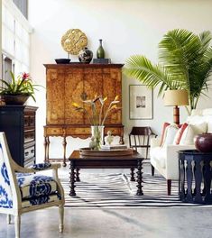 a living room filled with furniture and plants