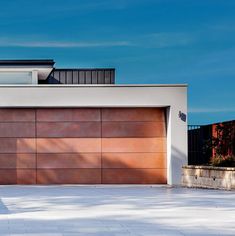 a modern house with an orange garage door