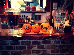 there are three pumpkins with words on them sitting on a counter top next to drinks