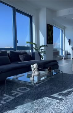 a modern living room with large windows overlooking the ocean