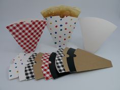 some paper cupcakes are lined up in different patterns and shapes, including one with a tie on it