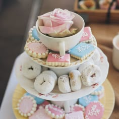 a three tiered cake stand with donuts, cookies and cupcakes on it