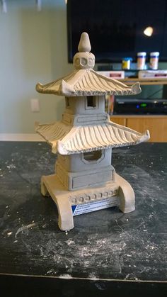 a small white building sitting on top of a table