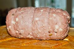 raw meat sitting on top of a wooden cutting board