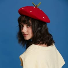 a woman wearing a red hat with white polka dots