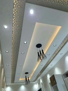 the ceiling is decorated with lights and chandeliers in this modern style living room