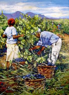 two women picking blueberries from a bush in the field with mountains in the background