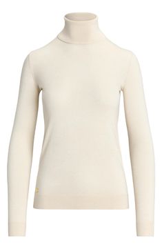 Silk-enriched yarns refine the fit and feel of this sweater knit with a slim, figure-skimming fit and finished with a tall turtleneck that keeps you warm as temperatures dip. Turtleneck Long sleeves with ribbed cuffs 42% modal, 33% silk, 25% recycled nylon Dry clean or machine wash, dry flat Imported Classic High Neck Sweater, Elegant Merino Wool Turtleneck For Layering, Elegant Funnel Neck Sweater With Ribbed Collar, Fitted Beige Turtleneck For Layering, Classic Knit Turtleneck, Elegant Turtleneck For Fall, Elegant Beige Turtleneck For Work, Classic Stretch Knit Turtleneck, Elegant Fitted Sweater With Ribbed Cuffs