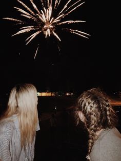 two women looking at fireworks in the sky