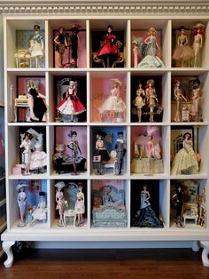 a shelf filled with lots of different types of dolls