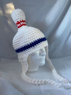 a crocheted white hat with red, white and blue stripes