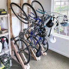 there are many bikes that are on the rack in this room and one is upside down