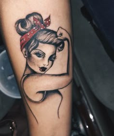 a woman's arm with a tattoo on it and a bow in her hair