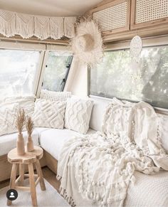 a white couch sitting under a window in a living room