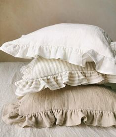 three pillows stacked on top of each other with ruffles in the bottom half