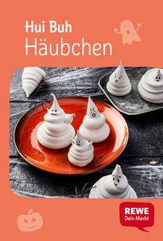 an orange plate topped with white meringue covered in icing and ghost faces