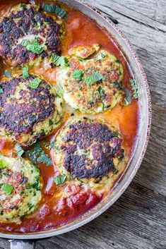 a pan filled with food sitting on top of a wooden table