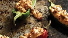 stuffed peppers with cheese on them sitting on a pan