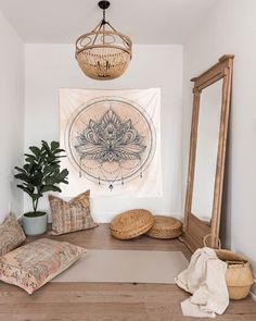 a room with a wooden floor and a large tapestry hanging on the wall above it