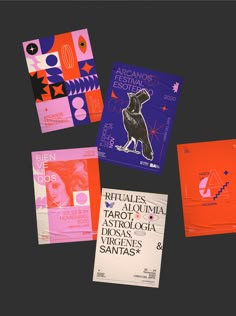 various posters and brochures are displayed on a black surface, including an orange dog