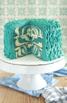 a blue and white cake sitting on top of a table