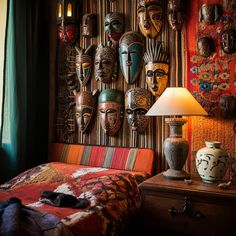 a bedroom with african masks hanging on the wall and a bed in front of it