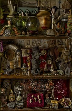 a shelf filled with lots of different types of figurines and knick knacks