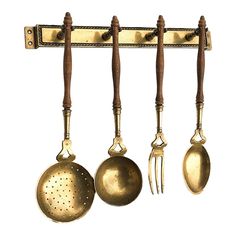 an old fashioned kitchen utensils hanging on a wall