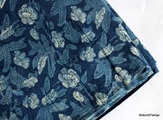 a blue and white cloth with leaves on it