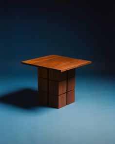 a small wooden table on a blue background