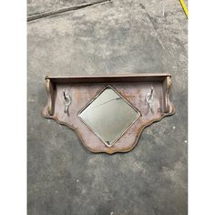 a mirror sitting on top of a metal shelf