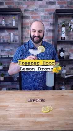 a man standing in front of a counter with lemons on it and the words freezer door lemon drops are over