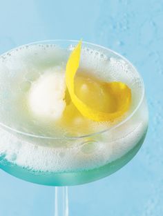 a drink with ice and lemon wedges on the rim