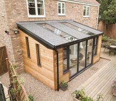 a small wooden house with a glass roof