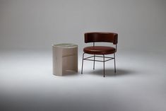 a chair next to a trash can on a white background