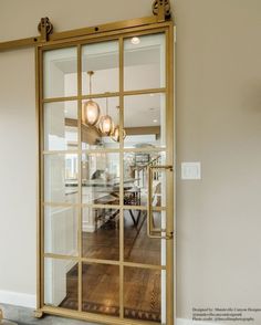 an open glass door leading to a dining room