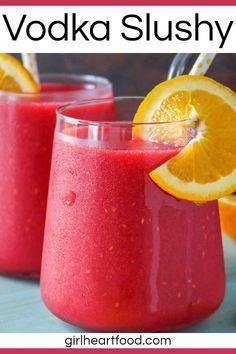 two glasses filled with vodka slushy and garnished with orange slices