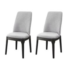 a pair of grey chairs sitting next to each other