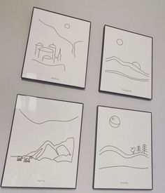 four drawings are displayed on the wall in front of two framed pictures, each with an image of a landscape