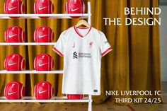 the nike liverpool fc kit is on display in front of a wall of red and white balls